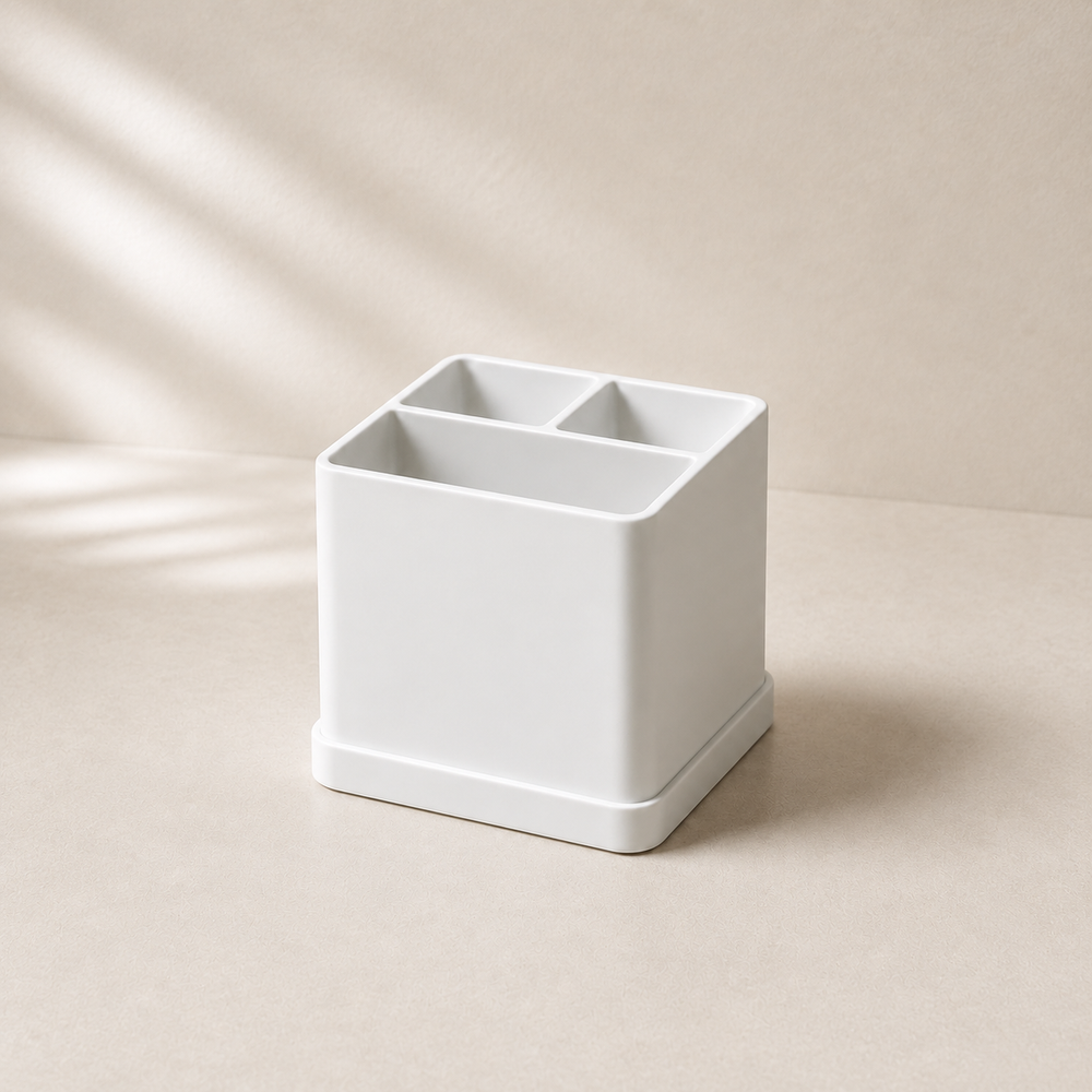 White three-compartment toothbrush holder in warm neutral studio setting