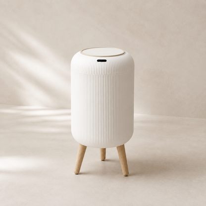 White touchless bathroom trash can in warm neutral studio setting