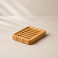 Bamboo slatted soap dish in warm neutral studio setting