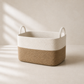 Large two-tone cotton rope laundry basket in warm neutral studio setting